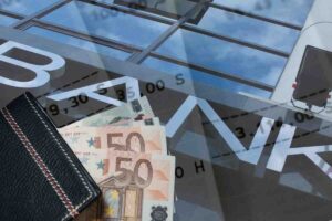 La scritta Bank con due banconote da 50 euro e dei documenti